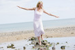 Woman walking on beach path smiling