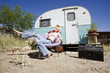 Photo : Woman in front of Travel Trailer Woman in front of Travel Trailer
