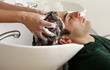 Young man having his hair  washed at a salon
