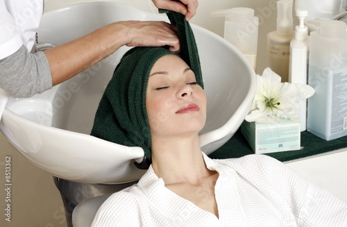 Photo: Young woman having her hair washed at a salon Young woman having her hair washed at a salon