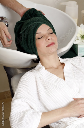 Photo: Young woman having her hair washed at a salon Young woman having her hair washed at a salon