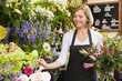 Photo : Woman working at flower shop smiling