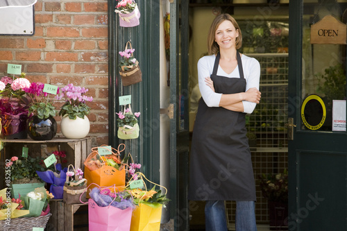 Photo: Woman working at flower shop smiling Woman working at flower shop smiling
