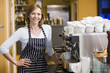 Photo: Woman making coffee in restaurant smiling Woman making coffee in restaurant smiling