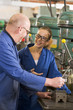 Two machinists working on machine