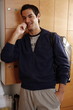 Man in locker room after work out talking on cell phone