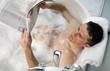 Man relaxing in bathtub with bubbles