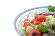 Italian salad in a bowl, against a white background.