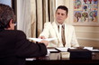 Two businessmen working in a hotel room