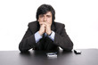 Young Businessman over a desk, full of thoughts