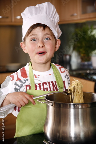 Photo: Boy cooking spaghetti Boy cooking spaghetti