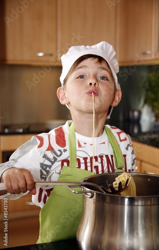 Photo: Boy cooking spaghetti Boy cooking spaghetti