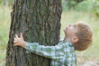 care of nature - little boy embrace a tree care of nature - little boy embrace a tree