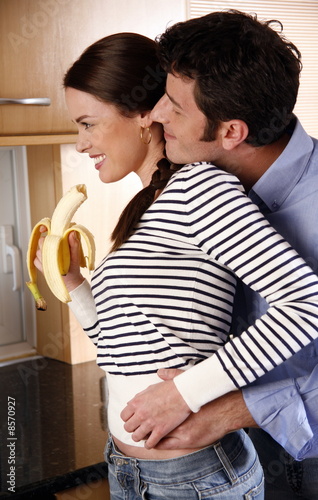 Photo: A young couple in the kitchen A young couple in the kitchen