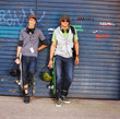 Portrait of happy young boys standing with skateboards and helme