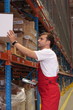 A worker with scanner in a factory maintaining stocks