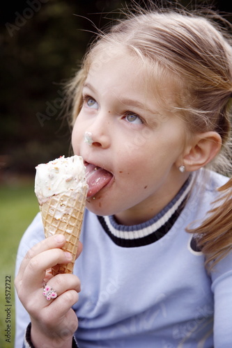 Photo: Young girl eating ice cream Young girl eating ice cream