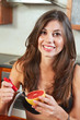 Sexy brunette eating breakfast