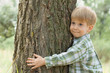 care for nature - little boy embrace a tree