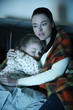 Mother and daughter watching television
