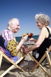 Photo: Senior couple with cocktails on beach Senior couple with cocktails on beach