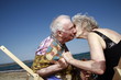 Photo: Senior couple with on beach kissing Senior couple with on beach kissing