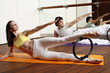 Young man and woman performing a pilates exercise