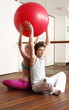 Young man and woman performing a pilates exercise