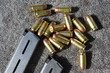 Gun magazine and bullets on carpet, close-up