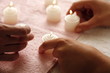 Hands with lit candles