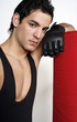 Young man leaning on punching bag