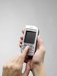Mobile phone in hand isolated on white background. Mobile phone in hand isolated on white background.