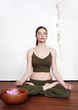 Young woman in a fitness class meditating