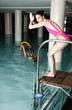 Young woman ready  to jump in the pool