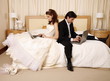 Bride and groom on laptops