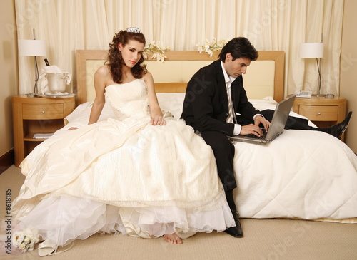 Photo: Bride waiting for groom to get off his laptop Bride waiting for groom to get off his laptop