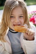 Young girl eating a doughnut