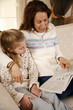 Grandmother relaxing with granddaughter
