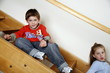 Tired children on staircase