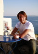 Young man sitting on balcony with a view