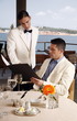 Man ordering from the menu to the waiter in restaurant