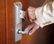 Man putting card key into hotel room door