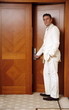 Man putting card key into hotel room door