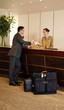 Man checking in  at the hotel reception desk