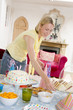 Woman at party setting out food and smiling