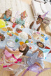 Photo: Young children at party sitting at table with food smiling Young children at party sitting at table with food smiling