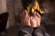 Photo: Father and son's Feet warming at a fireplace Father and son's Feet warming at a fireplace