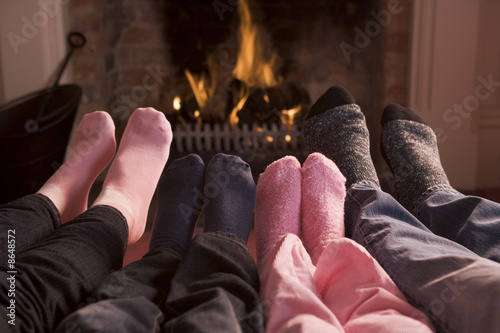 Photo: Family of Feet warming at a fireplace Family of Feet warming at a fireplace