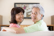 Photo: Couple watching television smiling Couple watching television smiling