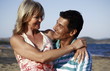 Photo: Mature adult couple hugging on beach Mature adult couple hugging on beach